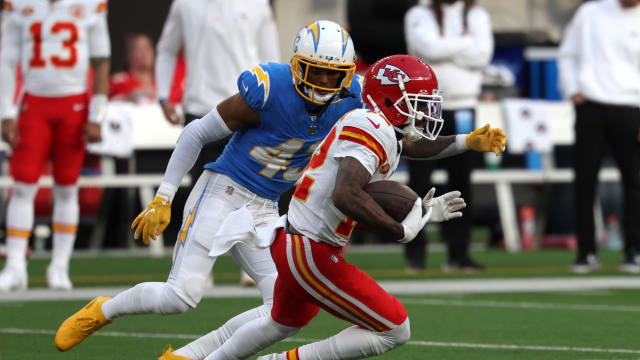 Jan 7, 2024; Inglewood, California, USA; Kansas City Chiefs wide receiver Mecole Hardman Jr. (12) runs with the ball as Los Angeles Chargers cornerback Michael Davis (43) defends during the second quarter at SoFi Stadium. Mandatory Credit: Kiyoshi Mio-USA TODAY Sports  